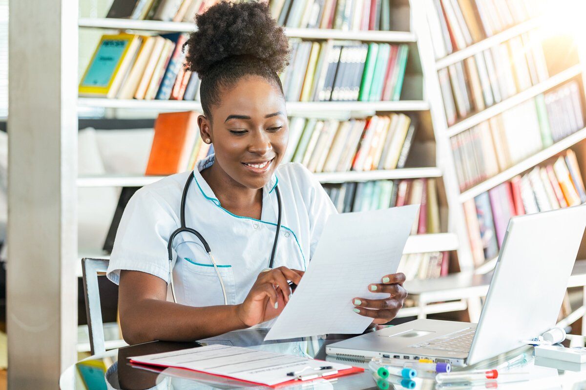 female-healthcare-worker-laptop-records